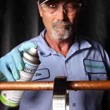 Man spraying pipe